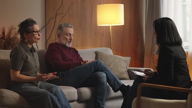 Psychologist counsels stressed mature woman and husband during couples therapy