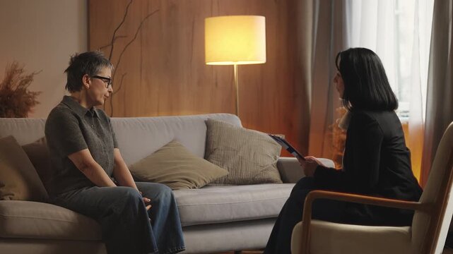 Sad woman in her 50s shares life problems with psychologist, seeking help