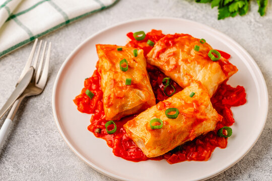 Delicious stuffed cabbage rolls served with tomato sauce