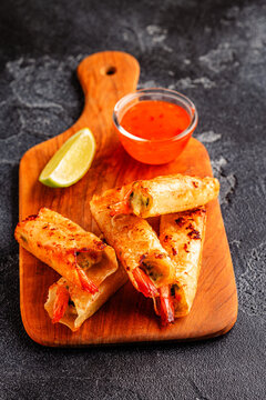 Fried spring rolls with shrimps served with sauce and lime