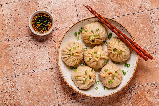 Dumplings served with green onions on a plate