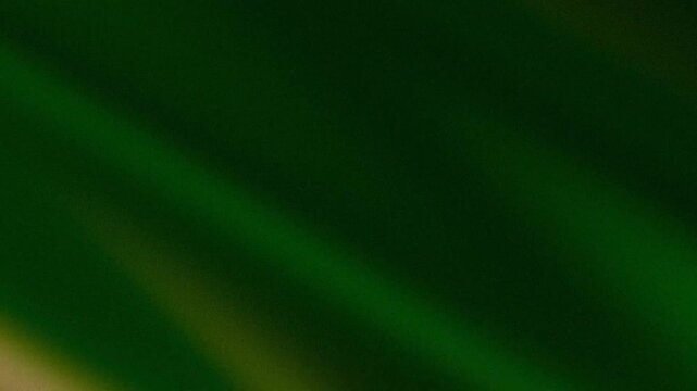 Abstract green background with diagonal light ray and grainy texture
