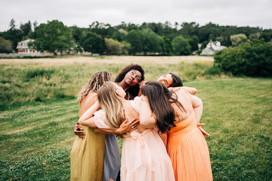 Diverse group of women share a supportive hug
