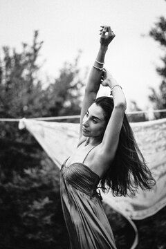 Carefree woman with long hair stretching outdoors