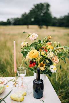Elegant picnic table with wildflower bouquet outside