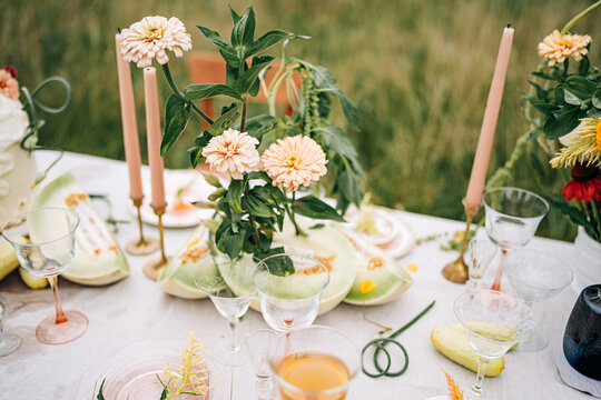 Elegant outdoor party table setting with fresh flowers