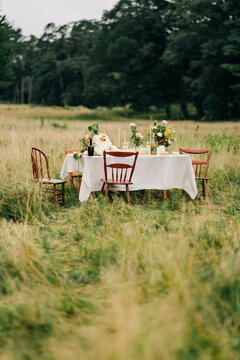 Elegant dinner party table set in a meadow