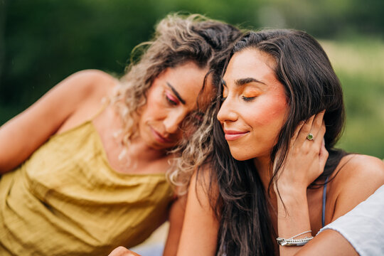 Two beautiful women share an intimate moment together