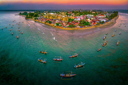 Sunset beach in Indonesia with golden waves and pristine white s