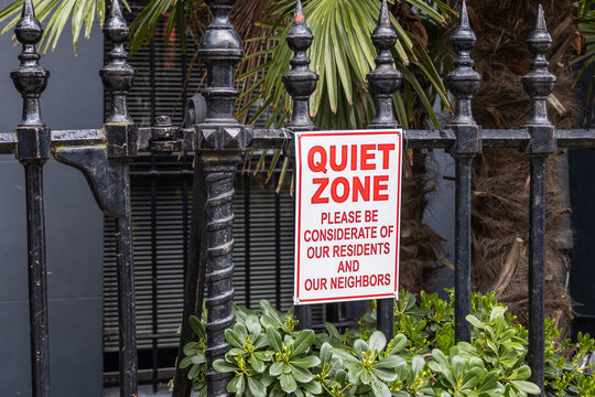 Quiet zone sign hanging on black wrought iron fence