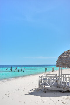 A wooden gazebo on a sandy beach on Timba Timba island, Semporna district, Borneo, Malaysia.