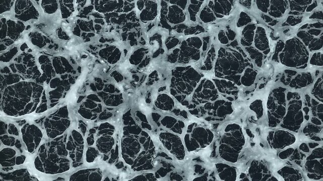 Drone perspective capturing black wastewater and aeration foam in an industrial treatment facility, highlighting biological treatment, water recycling, and sustainable pollution reduction. 4k.

