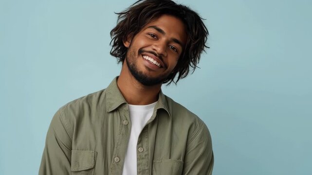 Smiling Adult Man Adjusting Casual Shirt in Portrait Against Blue Background