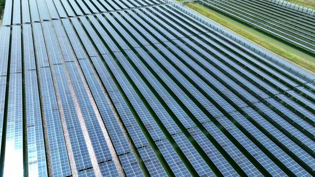 Aerial view of expansive solar panels installed in a structured pattern, representing eco friendly innovation, energy sustainability, and efficient solar power generation.
