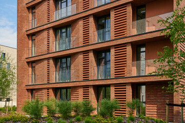 Fototapeta premium Modern residential brick building exterior with balconies