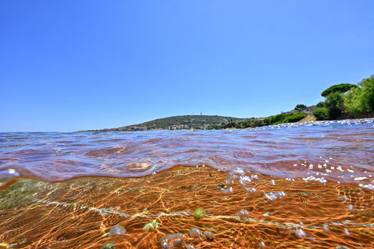 Split level underwater image of red rocks, Karfas, Chios Island, Greece with space for your text
