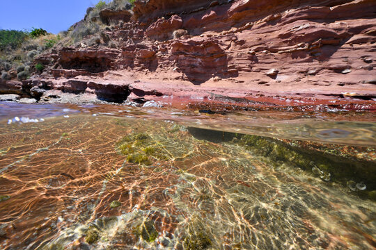 Half underwater image red rocks, Karfas, Chios Island, Greece        