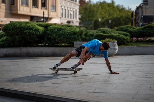 Skateboarder balancing on board performing urban trick