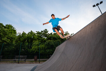 Skateboarder performing trick on ramp at skate park © Zoran Jesic