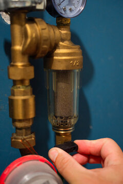 Draining water with a tap on a coarse filter in a private house on a water supply pipe