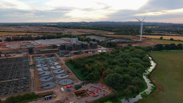 Aerial view of large municipal sewage treatment works and circular clarifier tanks in Leicestershire UK