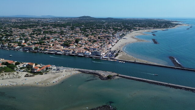 Aerial view of the Herault river mouth flowing into the Mediterranean Sea at Le Grau d'Agde, France