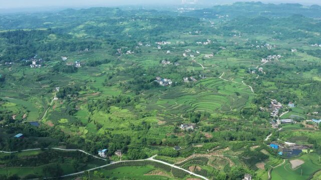 Aerial View of Green Terraced Fields and Rural Village in Rolling Hills