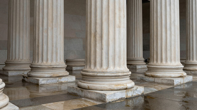 Fluted marble pillars define an ancient Greek and Roman style architectural colonnade