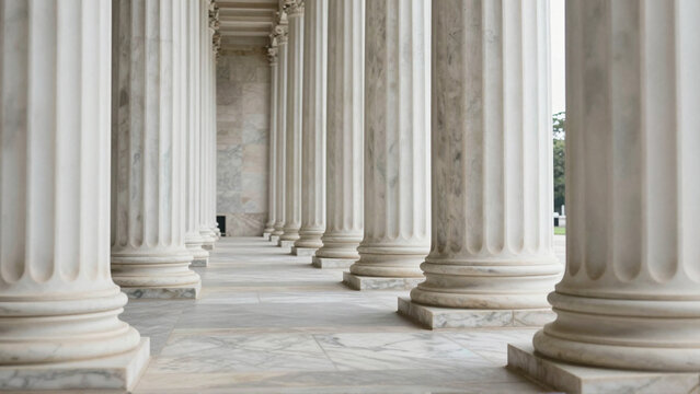 Marble pillars form a symmetrical colonnade in classical Greek and Roman architecture