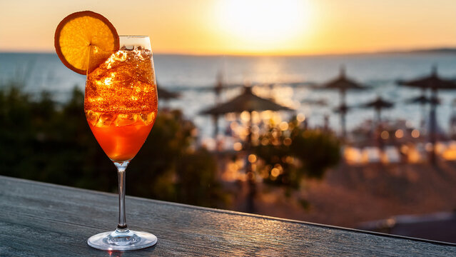 Vibrant orange spritz cocktail with condensation and blurred terrace background banner.