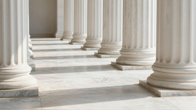 Rows of classical Greek and Roman marble pillars in sunlit architectural colonnade