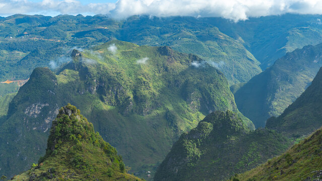 Scenic Green Mountain Range with Dramatic Peaks and Clouds
