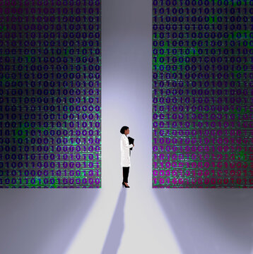 Scientist stands between walls of binary code in data center