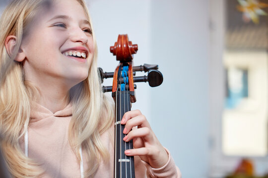 Portrait of happy girl with cello