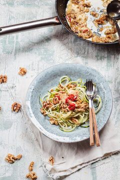 Spiralized zucchini and spicy walnut feta sauce on plate