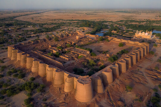 Aerial view of the historic Derawar Fort with its massive circular bastions and mud-brick walls set against the vast desert landscape in Derawar, Punjab, Pakistan.