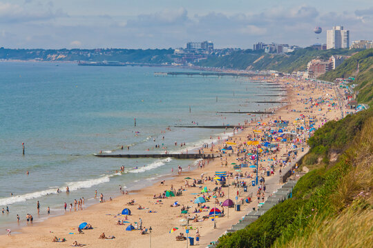 The sunny beach features the sea and cliff line in Bournemouth