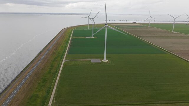 Coastal wind turbines at Almere Pampus wind farm in Flevoland, Netherlands, aerial view