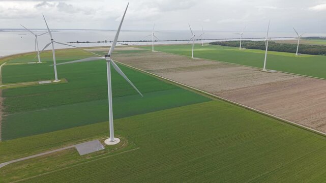 Aerial view of offshore-style wind turbines along the coast of Almere Pampus, Netherlands