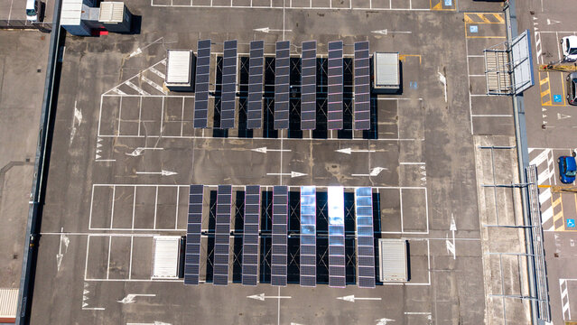 Aerial view of solar panel carports installed over parking spaces at the Pittarello store in Peschiera Borromeo, Lombardia, Italy.