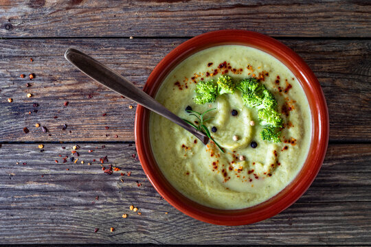 Cream of broccoli soup on wooden table. Top view

