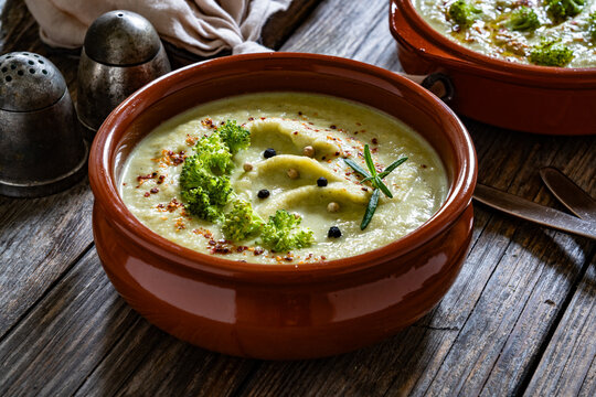Cream of broccoli soup on wooden table
