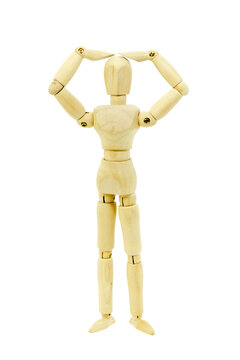 Wooden artist mannequin with both arms raised to head showing stress or headache gesture. Isolated on white background. Articulated figure for drawing reference and anatomy study.