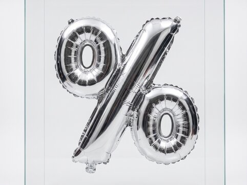 Metallic silver percent balloon squished between clear glass