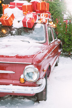 Vintage car with snowy decoration carries festive gifts