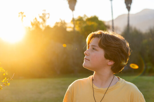 portrait of 13 year old boy smiling at sunset
