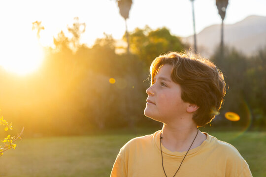 portrait of 13 year old boy smiling at sunset