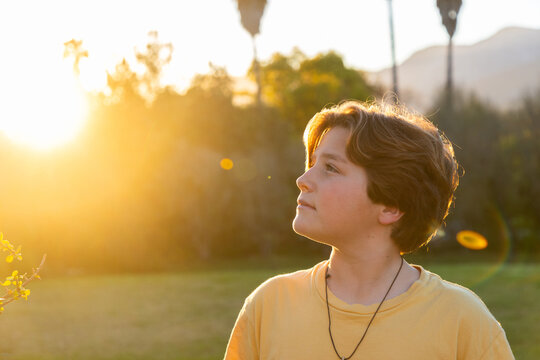 portrait of 13 year old boy smiling at sunset