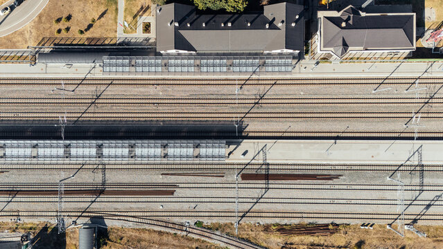 Aerial view of Indjija Pustara Railway Station featuring parallel train tracks, platforms, and station buildings in Indjija, Vojvodina, Serbia.