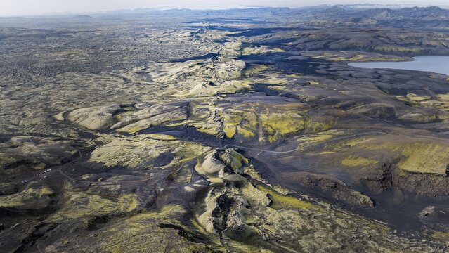 Aerial view of the Laki fissure, a volcanic crater row with dark lava fields and moss-covered terrain in the highlands of Kirkjubaejarklaustur, Skaftarhreppur, Iceland.